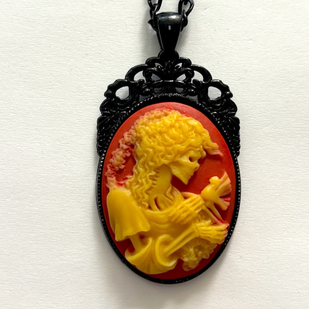 Red and yellow Skeleton lady holding a bird cameo Victorian Style Necklace